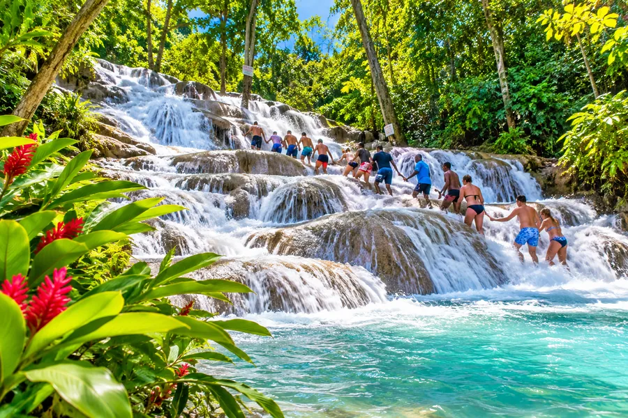 Visitors climbing the cascading waterfalls at Dunn's River Falls in Jamaica
